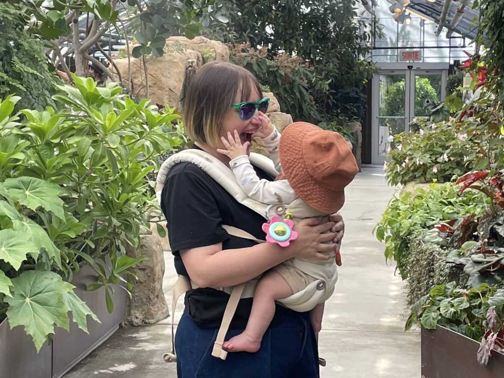 Sabrina, wearing her baby at the Botanical Gardens of Montreal